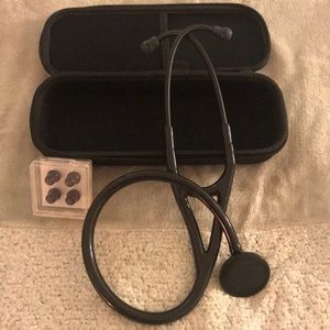 Stethoscope with extra ear pieces and black case.